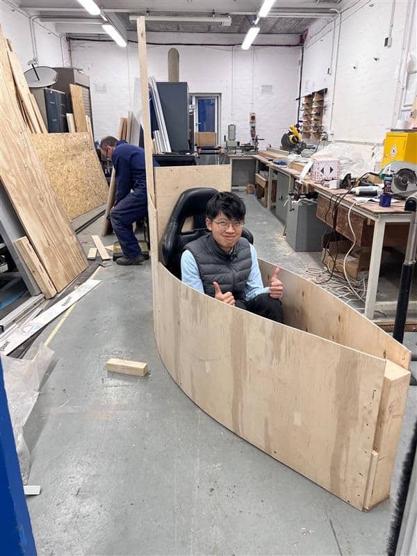 Volunteers fitting components to the soapbox chassis